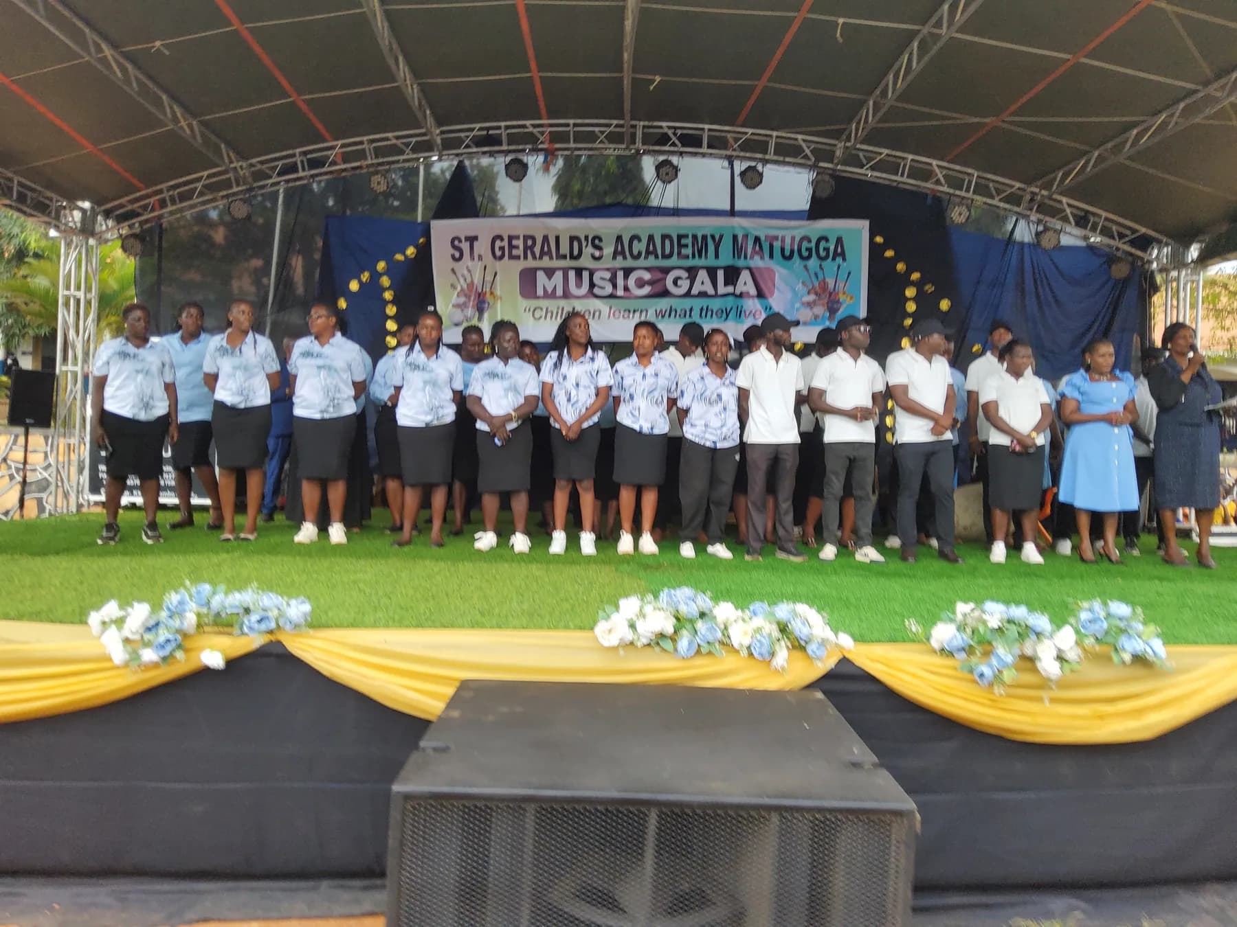 The St. Gerald’s Academy staff assembled across the Music Gala stage