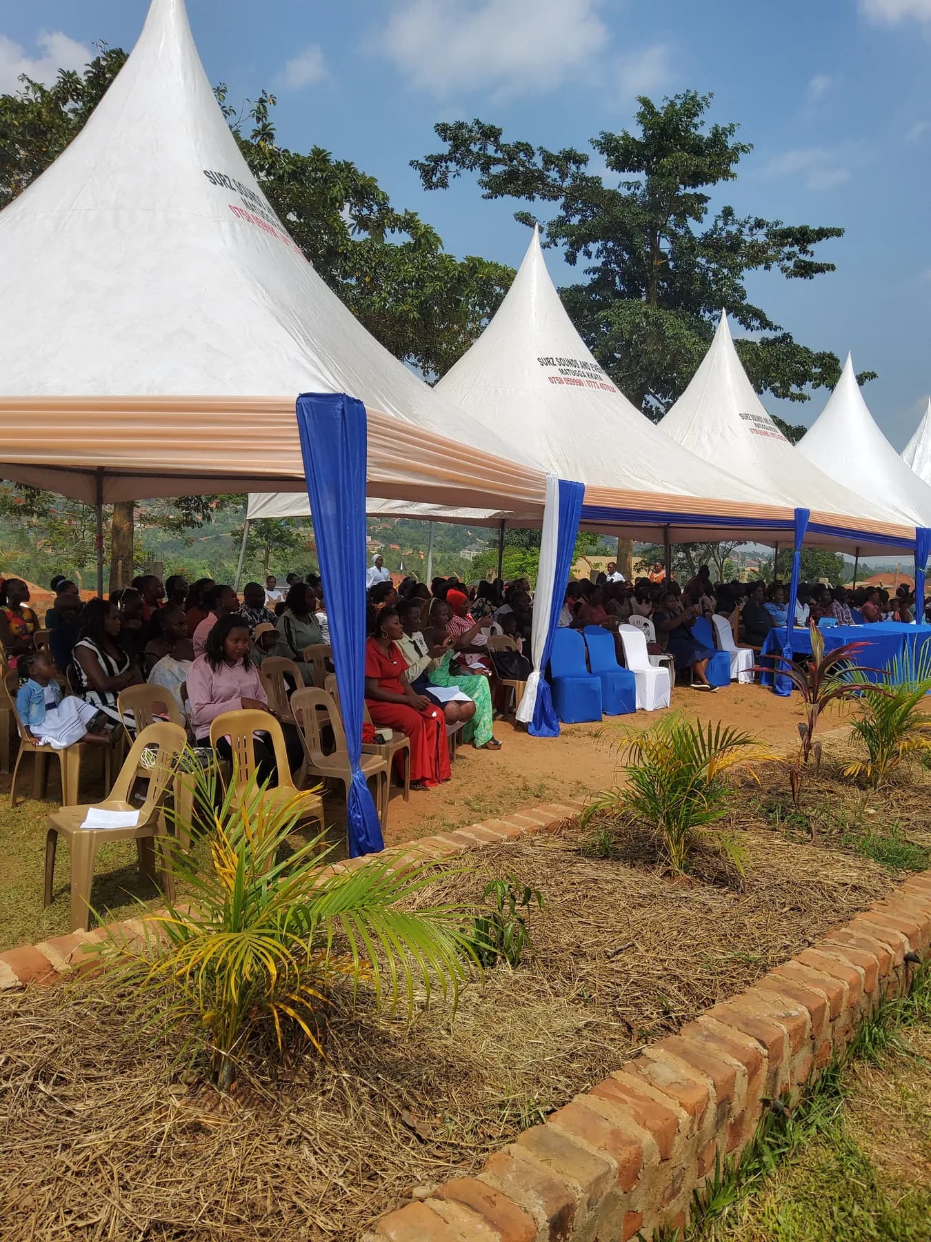 Families and guests seated beneath decorated white tents at the school Music Gala