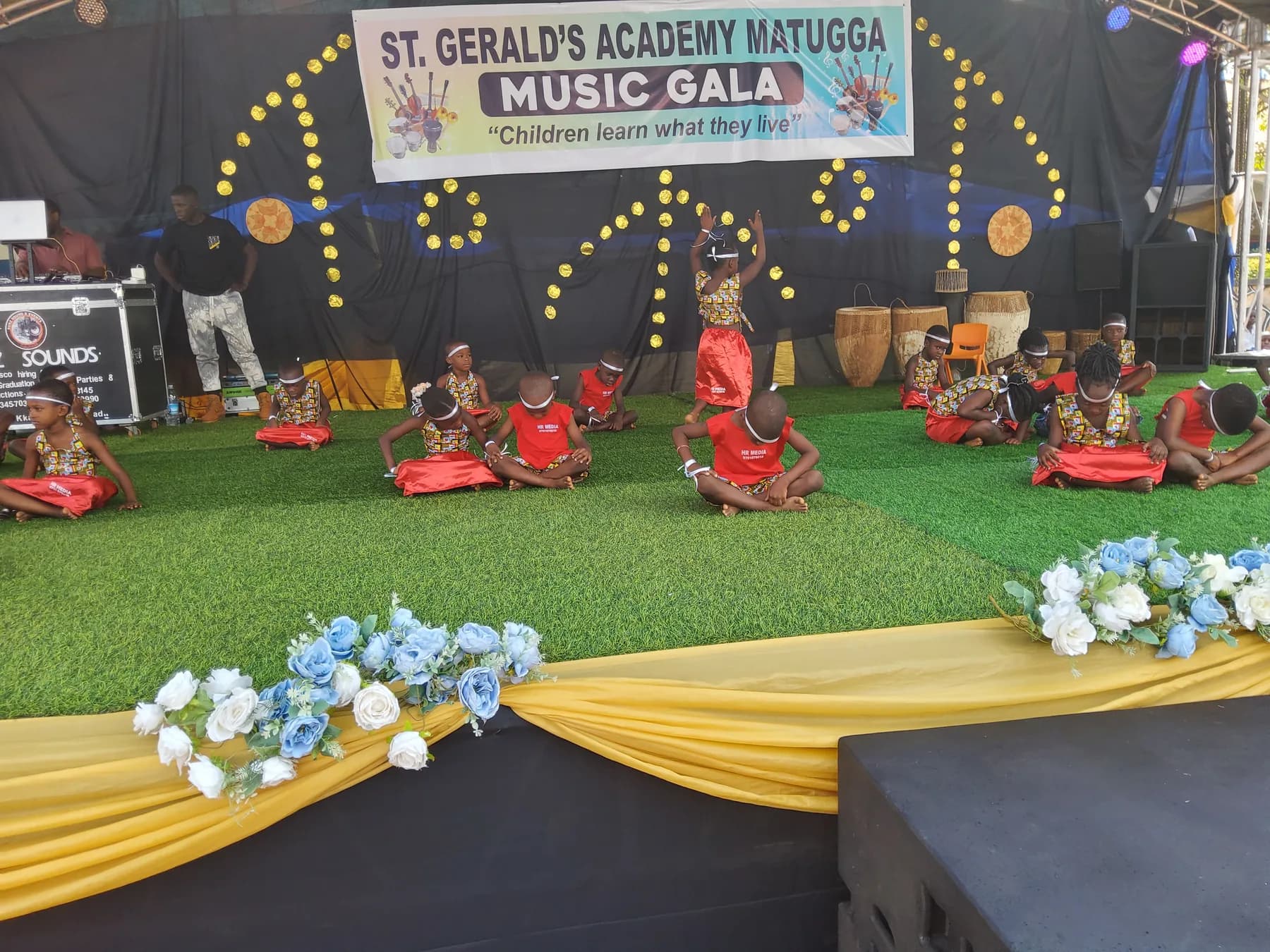 Learners performing in red and green at the St. Gerald’s Academy Music Gala